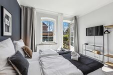 Ein Schlafzimmer bietet direkten Zugang zum Garten und dient gleichzeitig als Raucherbereich – komfortabel und wettergeschützt.