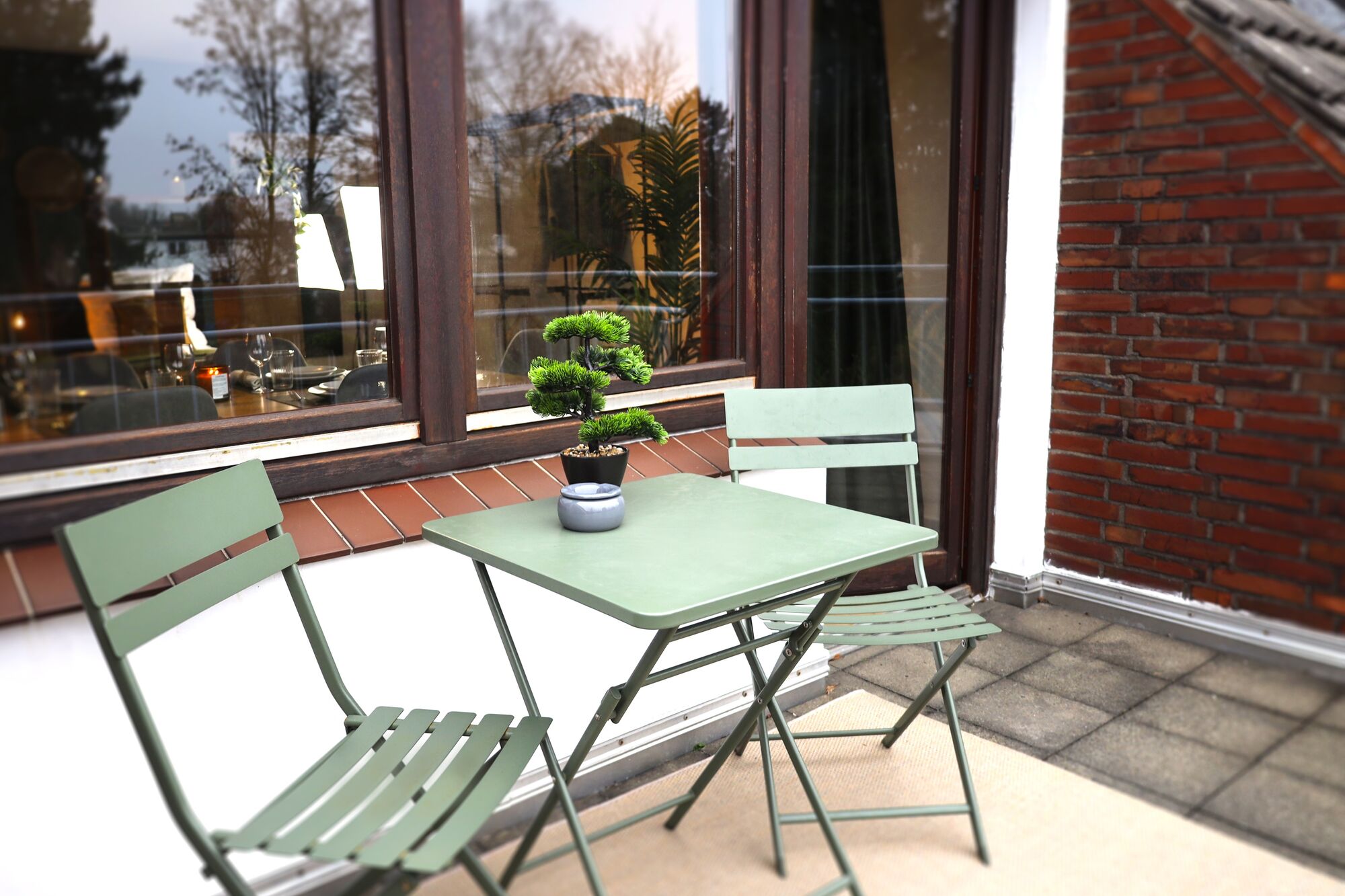 Gemütlicher Balkon mit Sitzgelegenheit Kleiner, ruhiger Balkon mit Tisch und zwei Stühlen